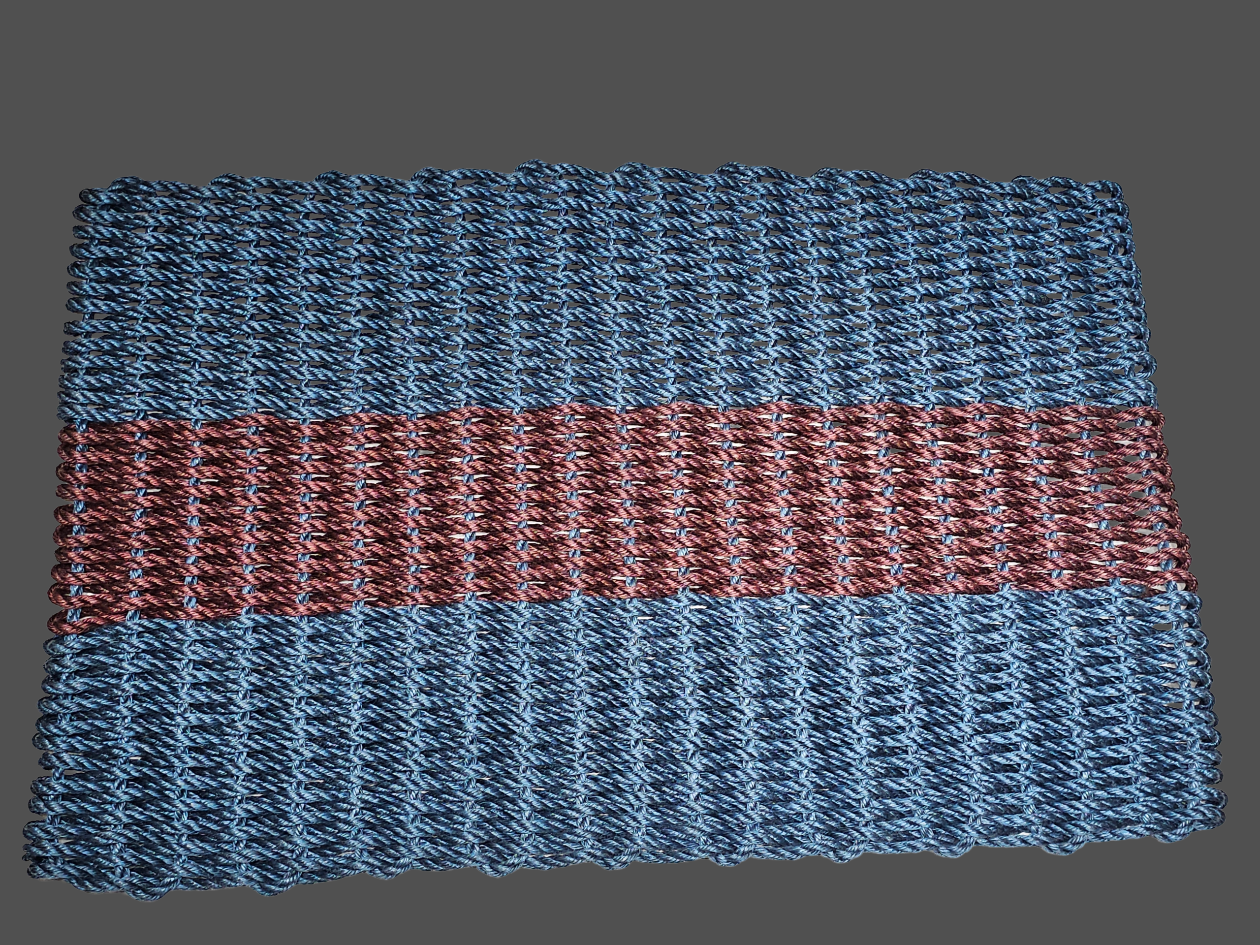 Handwoven lobster rope doormat in navy with one burgundy stripe